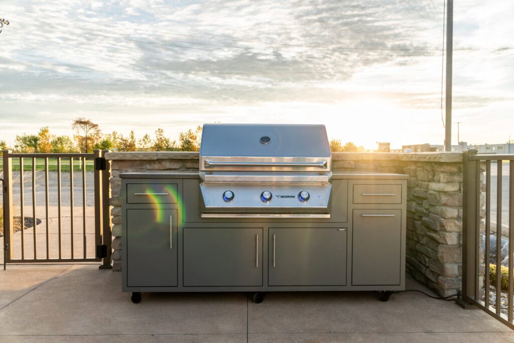 Modern Challenger Designs outdoor grill with storage, perfect for backyard cooking.